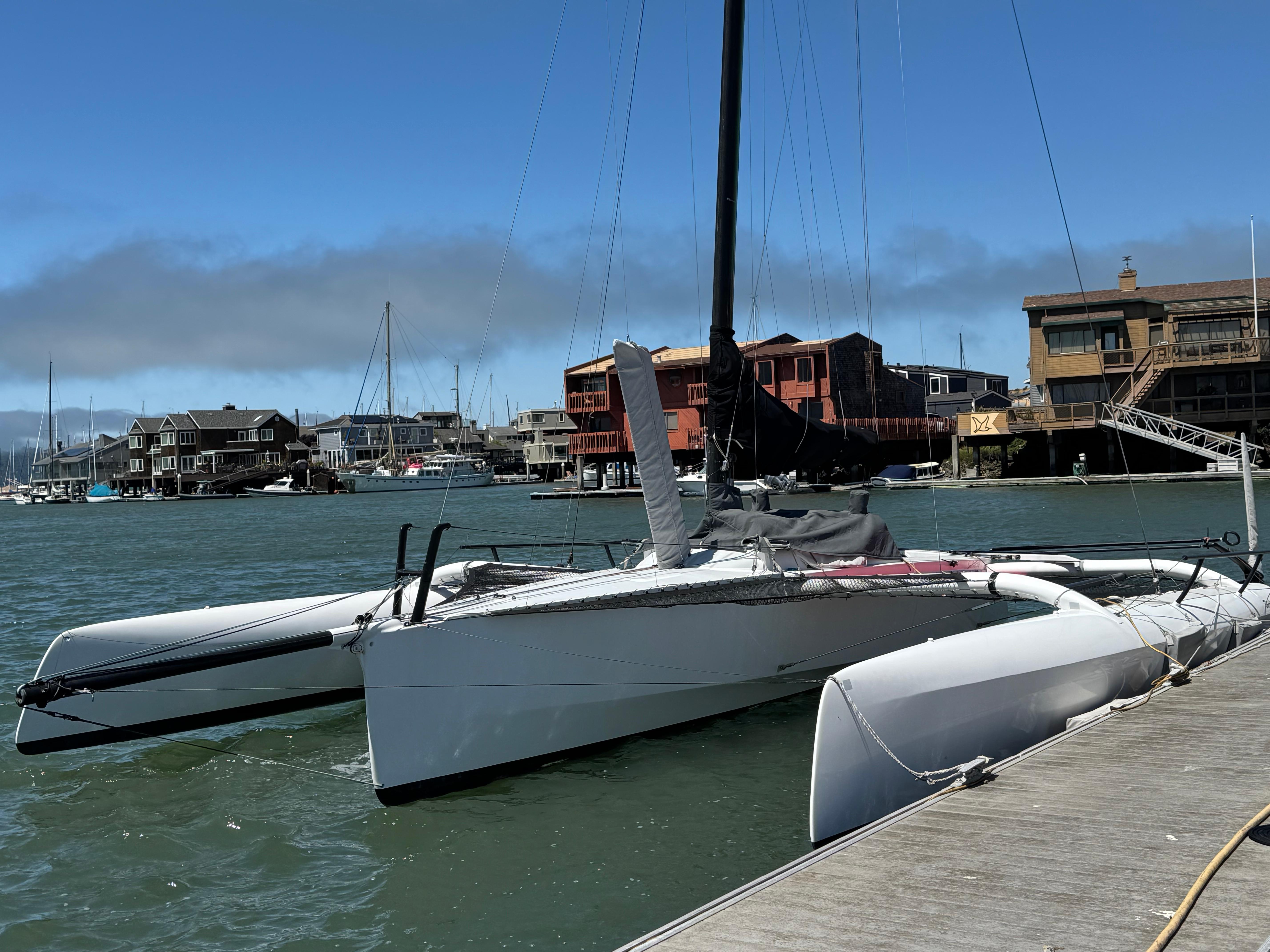 Marstrom Seacart 30 2015 Marstrom Seacart 30 trimaran docked in a marina with waterfront buildings.
