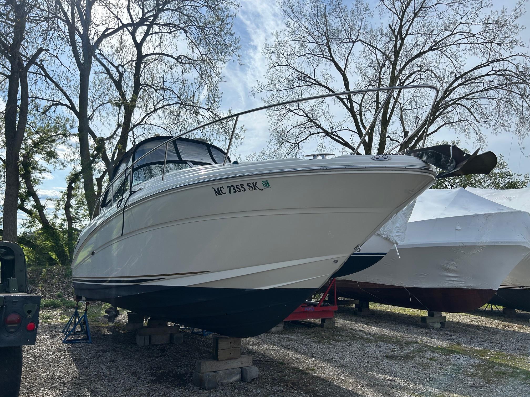 Sea Ray 300 Sundancer 2002 Sea Ray 300 Sundancer boat on blocks, surrounded by trees and other covered boats.