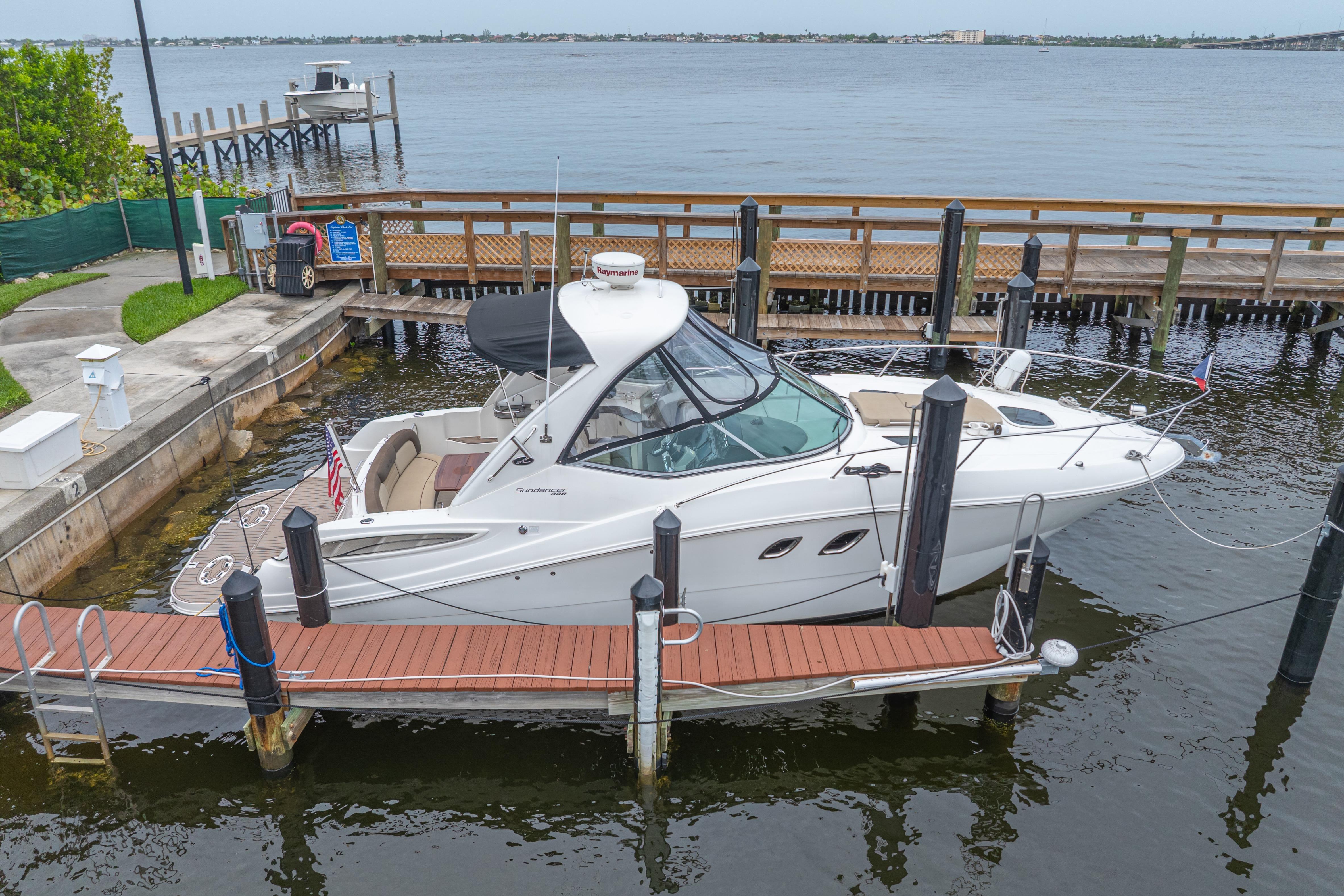 Sea Ray 330 Sundancer 2014 Sea Ray 330 Sundancer docked at marina with scenic waterfront view.
