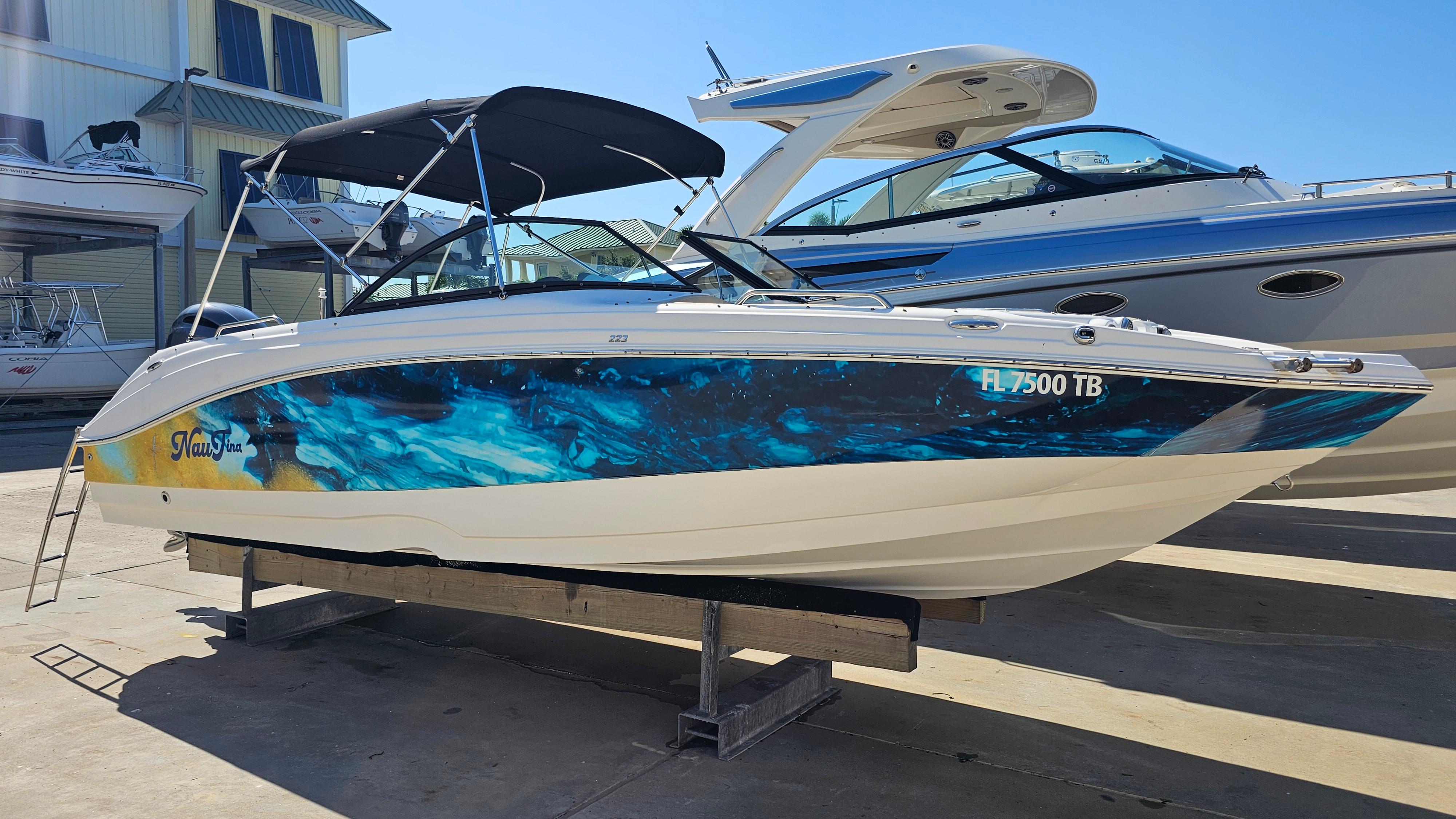 NauticStar 223 DC Deck 2022 NauticStar 223 DC Deck boat with vibrant blue and yellow hull design.