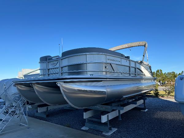 Bennington 24 MFB 2025 Bennington 24 MFB pontoon boat on display under clear blue sky.