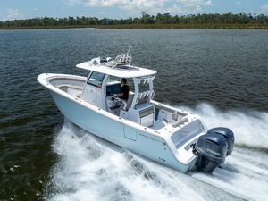 Sportsman Open 302 Center Console 2021 Sportsman Open 302 Center Console boat cruising on a lake.