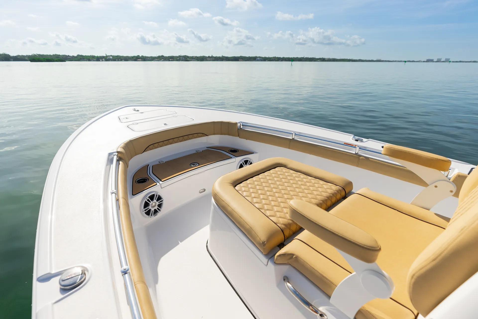 Sportsman Masters 267OE Bay Boat 2026 Sportsman Masters 267OE Bay Boat interior with tan seating on calm water.