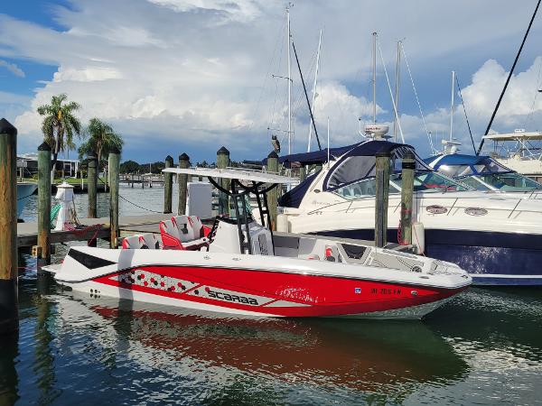 Scarab 255 Open ID 2019 Scarab 255 Open ID boat docked at marina with other boats.