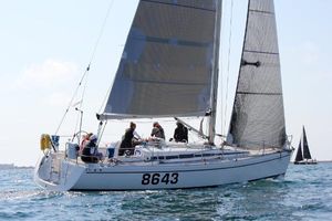 Arcona 370 Sailing yacht Arcona 370, 2004 model, on open water with crew onboard.