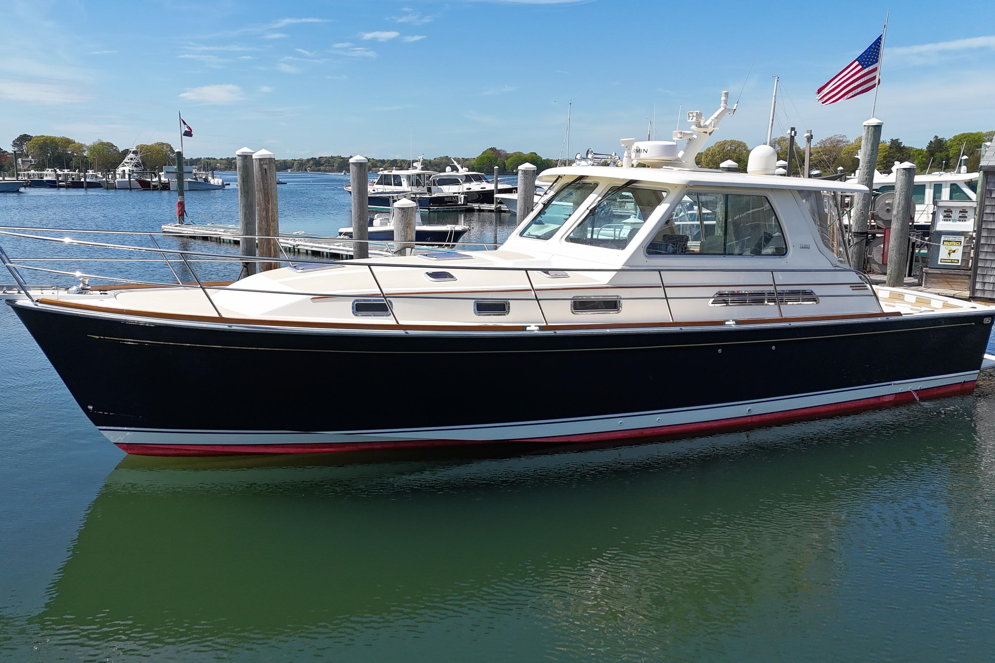 Sabre 42 Express 2009 Sabre 42 Express yacht docked in a marina, featuring sleek design and American flag.