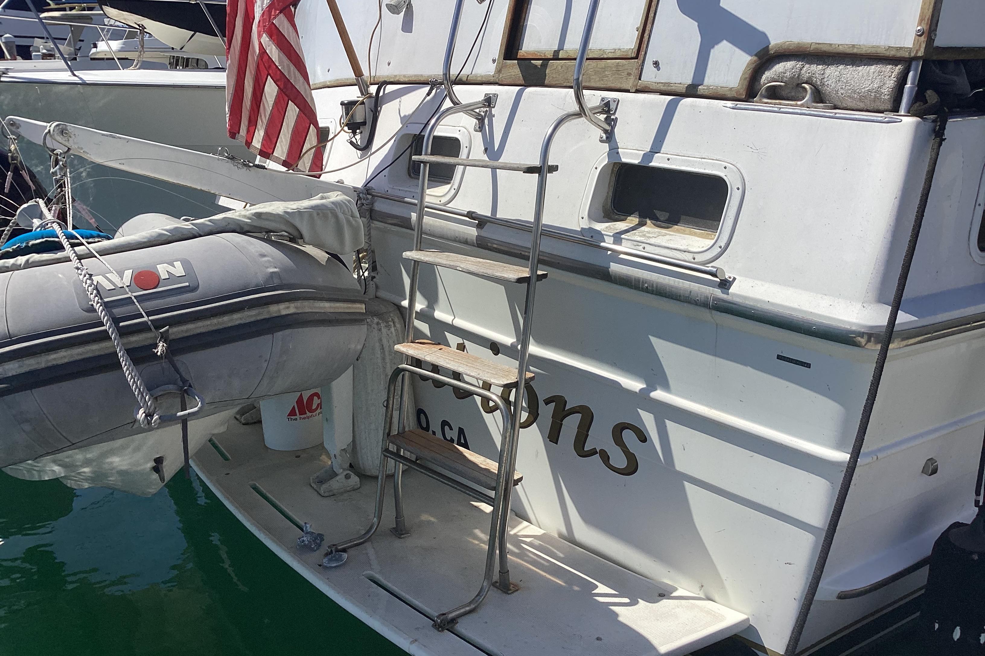 Spindrift 52 Motor Yacht 1984 Spindrift 52 Motor Yacht with dinghy and American flag at dock.