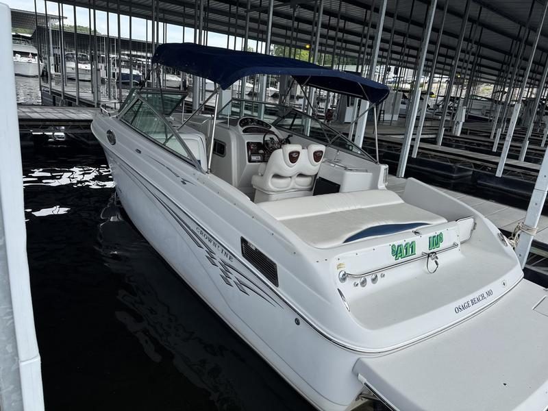 Crownline 290 BR 2006 Crownline 290 BR boat docked in a marina with blue canopy.