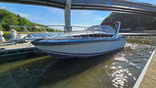 Formula 26 PC 1988 Formula 26 PC boat docked under a bridge on a sunny day.