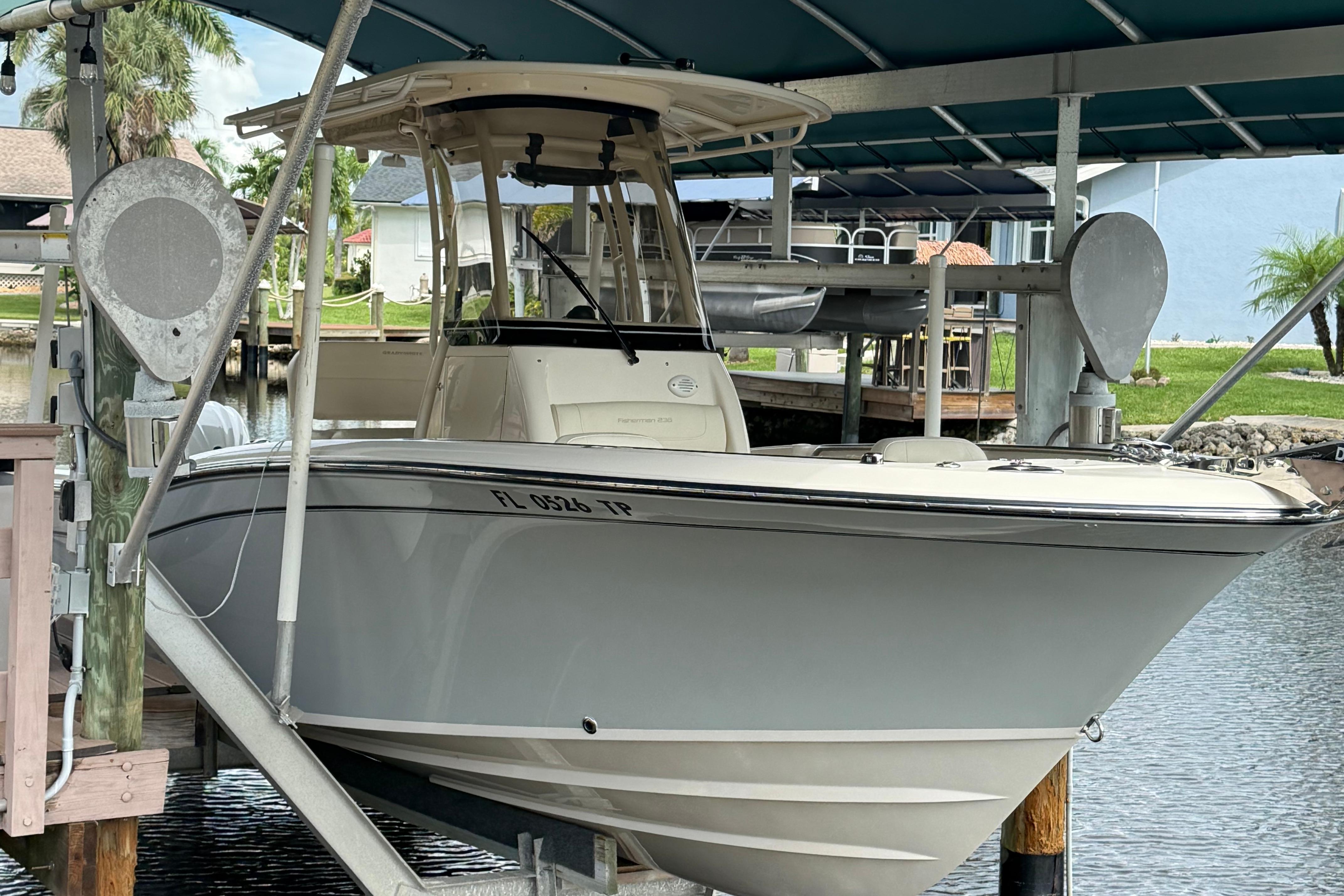Grady-White Fisherman 236 2021 Grady-White Fisherman 236 boat docked under a canopy in a marina.