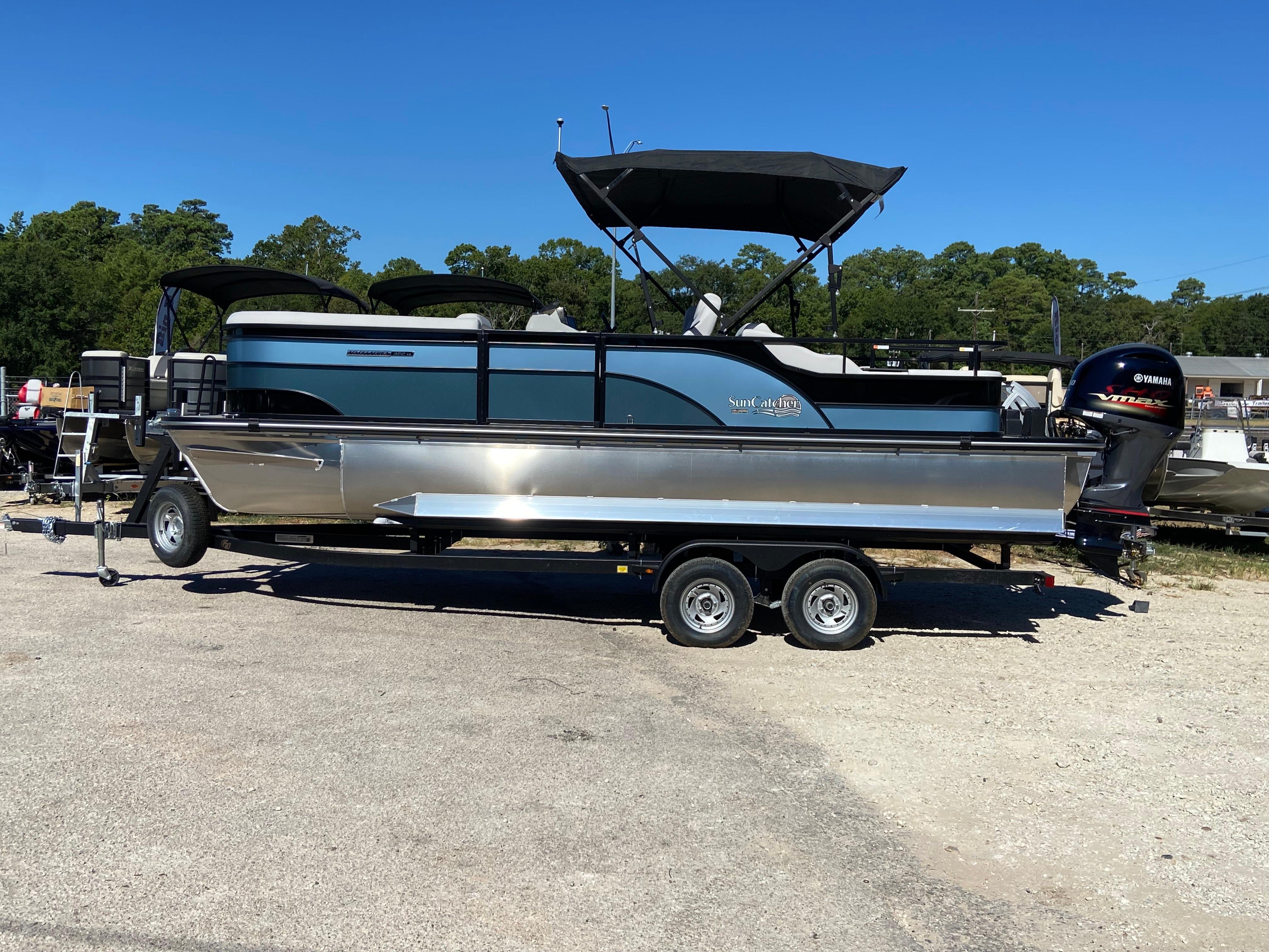 SunCatcher Select 322SS 2023 SunCatcher Select 322SS pontoon boat on trailer, outdoors, sunny day.