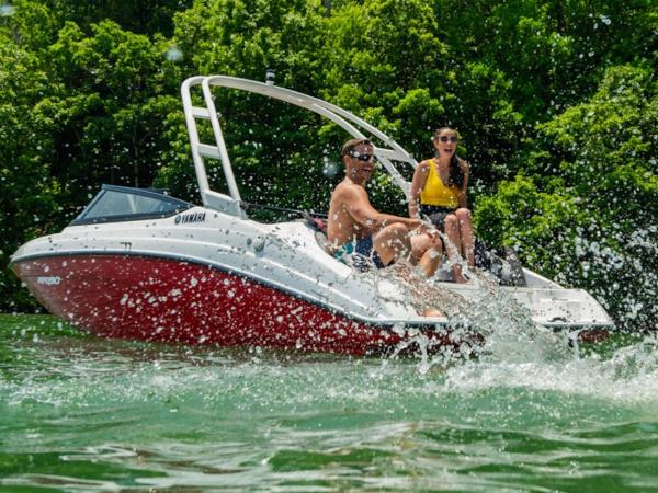 Yamaha Boats SX190 2024 Yamaha Boats SX190 on water with two people enjoying the ride.