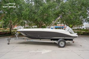 Hurricane SunDeck Sport 205 OB 2021 Hurricane SunDeck Sport 205 OB boat on trailer, parked outdoors with trees in background.