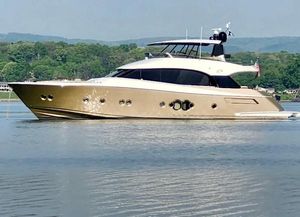 Monte Carlo Yachts 76 Luxurious 2012 Monte Carlo Yachts 76 cruising on a serene lake with lush green hills.