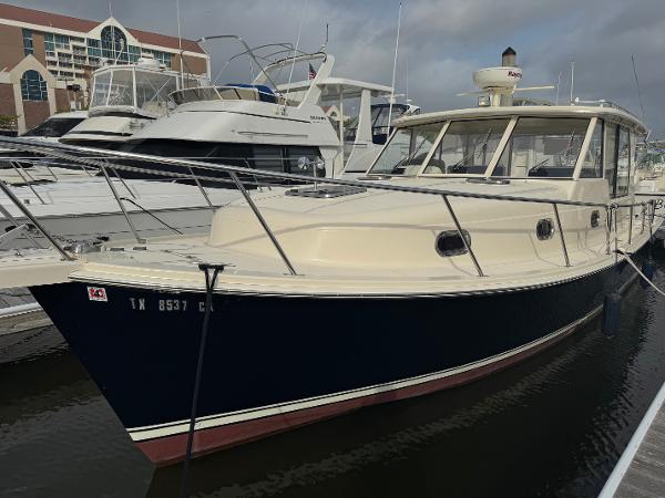 Mainship Pilot 34 2008 Mainship Pilot 34 docked at marina, featuring sleek design and spacious cabin.
