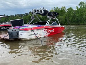 MasterCraft XStar 2006 MasterCraft XStar boat on a lake, featuring a vibrant red and white design.