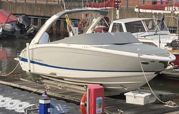 Regal LX6 2020 Regal LX6 boat docked at a marina, covered and secured.