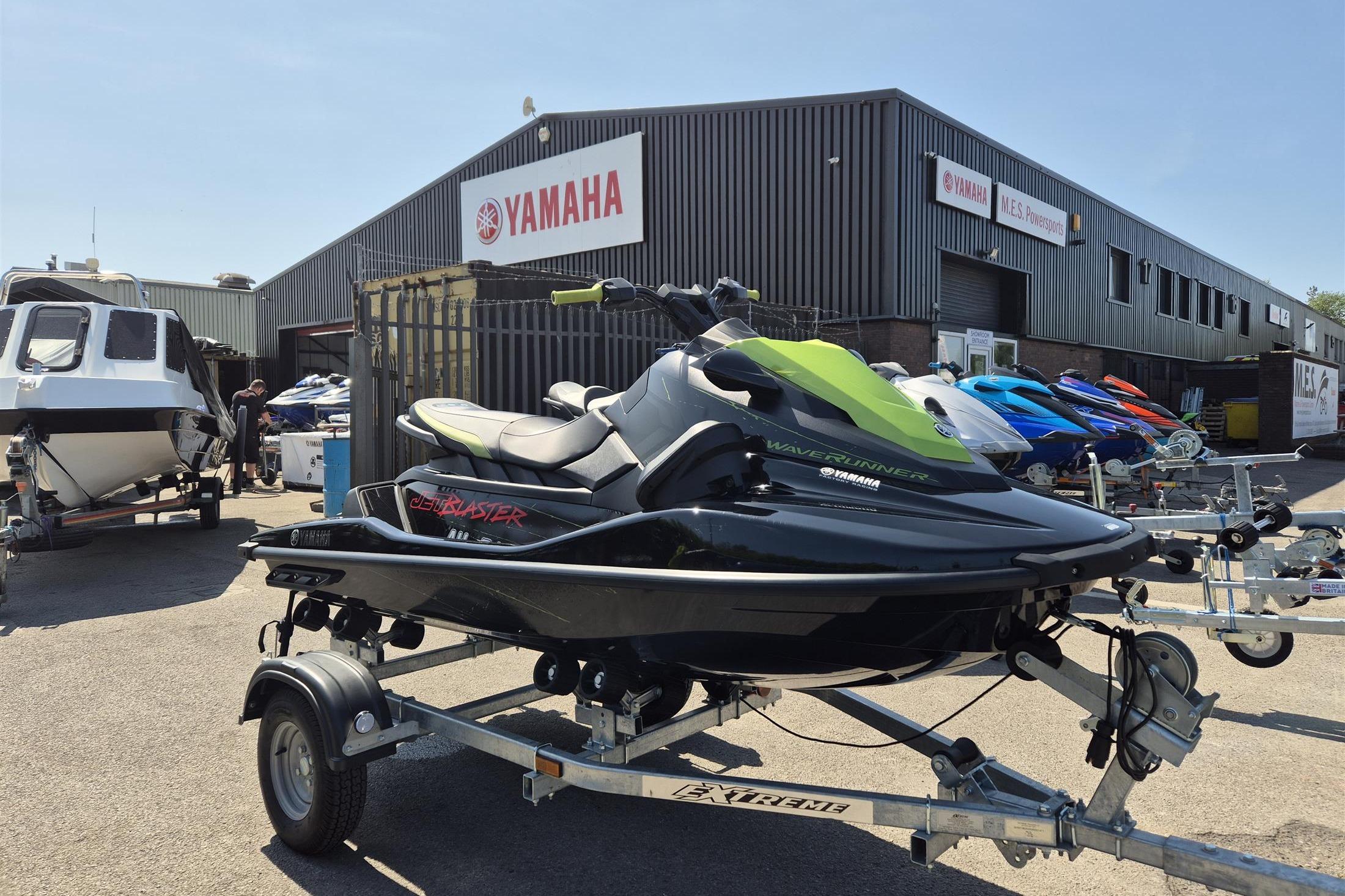 Yamaha WaveRunner JetBlaster 2023 Yamaha WaveRunner JetBlaster on trailer outside dealership, showcasing sleek design.