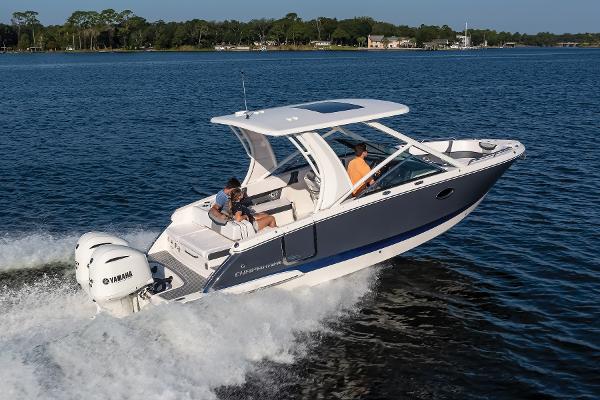 Chaparral 280 OSX 2025 Chaparral 280 OSX boat cruising on a lake with Yamaha engines.