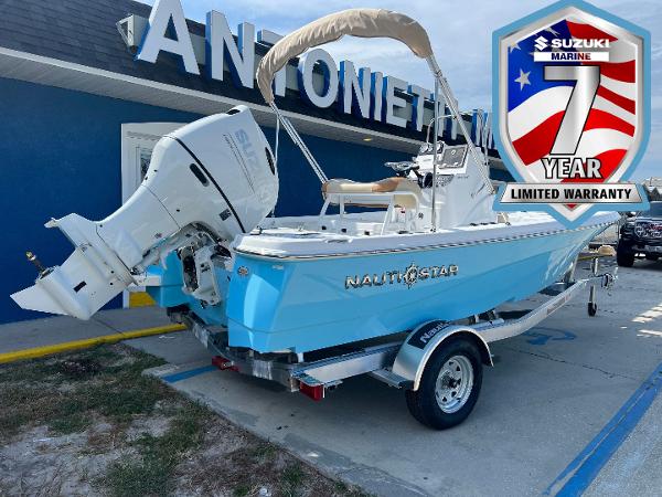 NauticStar 194 Bay 2025 NauticStar 194 Bay boat with Suzuki engine, displayed outside dealership, featuring 7-year warranty badge.