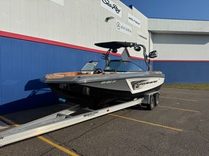 Nautique GS 24 2019 Nautique GS 24 boat on trailer outside dealership building.