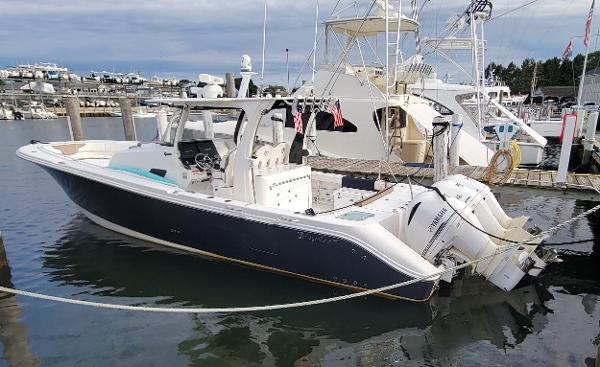 Edgewater 370CC 2018 Edgewater 370CC boat docked in marina, featuring sleek design and powerful engines.