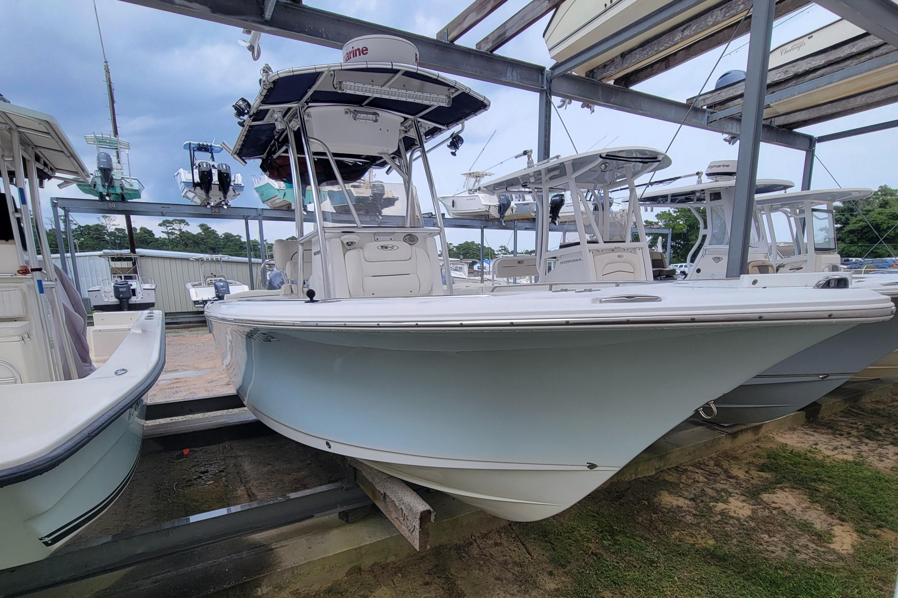 Sea Hunt Ultra 234 2016 Sea Hunt Ultra 234 boat in storage, surrounded by other vessels.