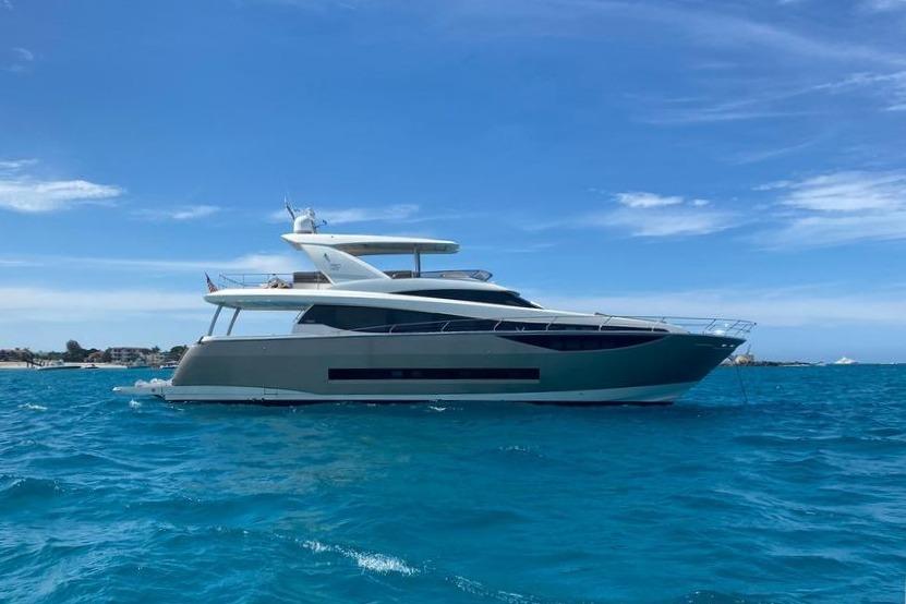 Prestige 750 Luxurious 2016 Prestige 750 yacht cruising on vibrant blue ocean waters.