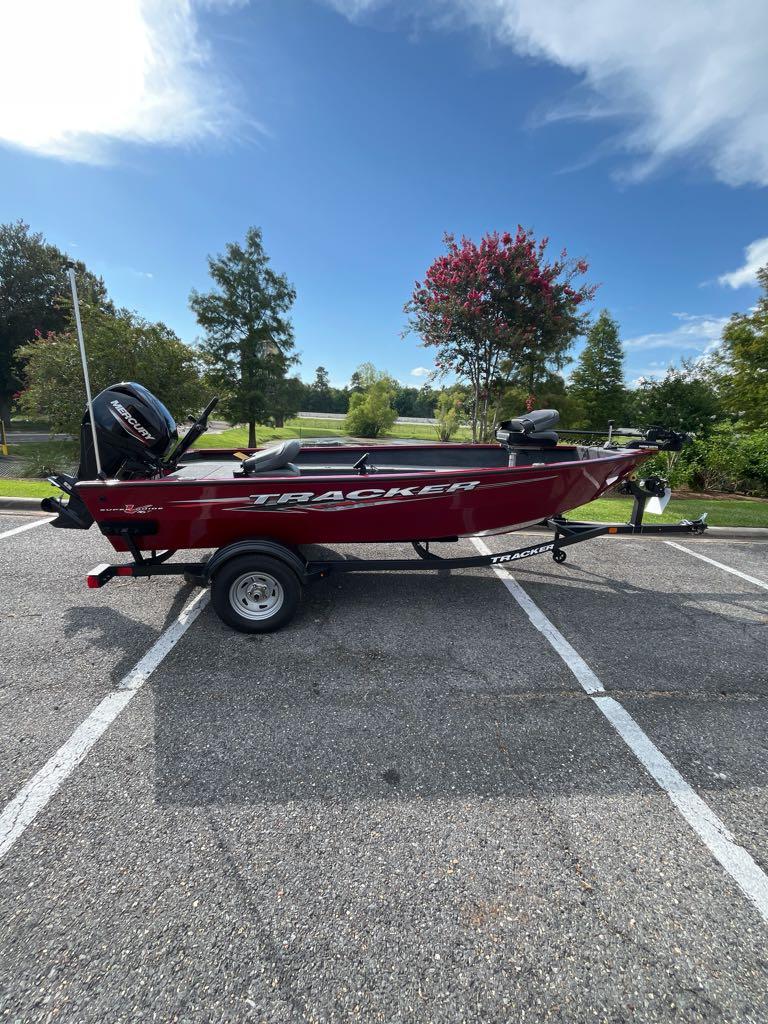 Tracker Super Guide V-16 T 2025 Tracker Super Guide V-16 T boat on trailer in parking lot.