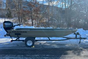 Tracker Grizzly 1754 Utility 2026 Tracker Grizzly 1754 Utility boat on trailer, snowy background, Mercury outboard motor.
