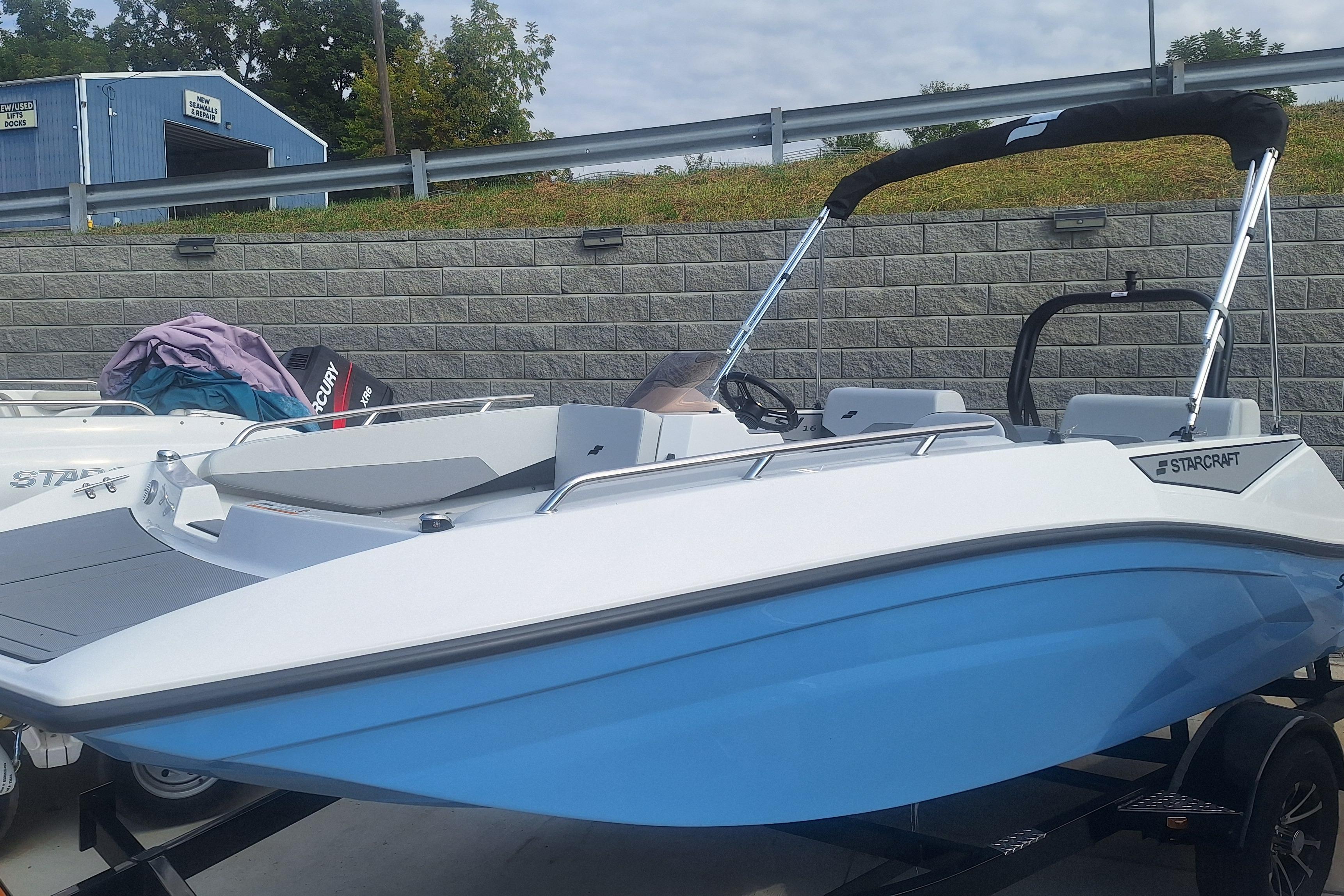 Starcraft SV 16 OB 2026 Starcraft SV 16 OB boat with blue hull and black canopy on trailer.