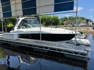 Monterey 335 Sport Yacht 2019 Monterey 335 SY boat docked on calm water under a canopy.