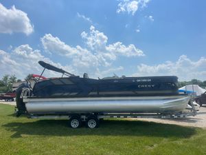 Crest Caribbean LX 250 CP3 2022 Crest Caribbean LX 250 CP3 pontoon boat on trailer under blue sky.