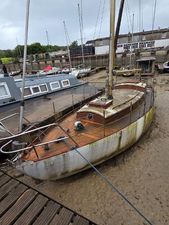 Nicholson Marine 1954 Nicholson Marine boat in a dry dock, showing weathered wooden deck and hull.