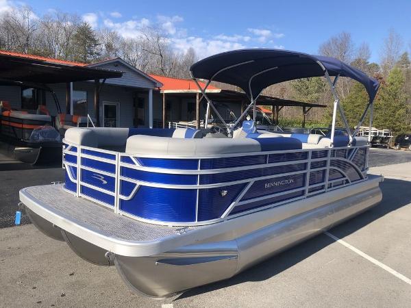 Bennington 20 SSR-SPS 2024 Bennington 20 SSR-SPS pontoon boat with blue exterior and canopy, parked outdoors.