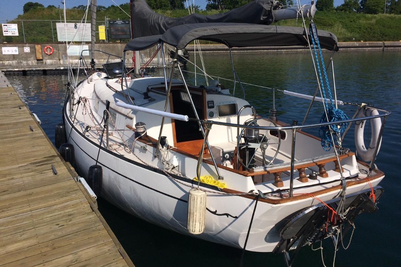 Bayfield 32 Cutter 1975 Bayfield 32 Cutter sailboat docked at a marina, featuring classic design and rigging.