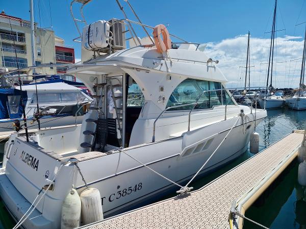 Beneteau Antares 9.80 2005 Beneteau Antares 980 docked at a marina under a clear blue sky.