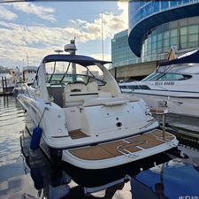 Sea Ray 360 Sundancer 2004 Sea Ray 360 Sundancer yacht docked at marina, modern buildings in background.