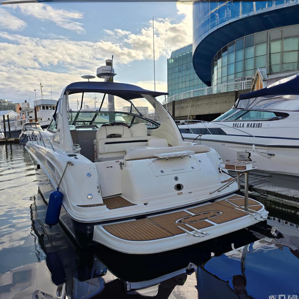 Sea Ray 360 Sundancer 2004 Sea Ray 360 Sundancer yacht docked at marina, modern buildings in background.