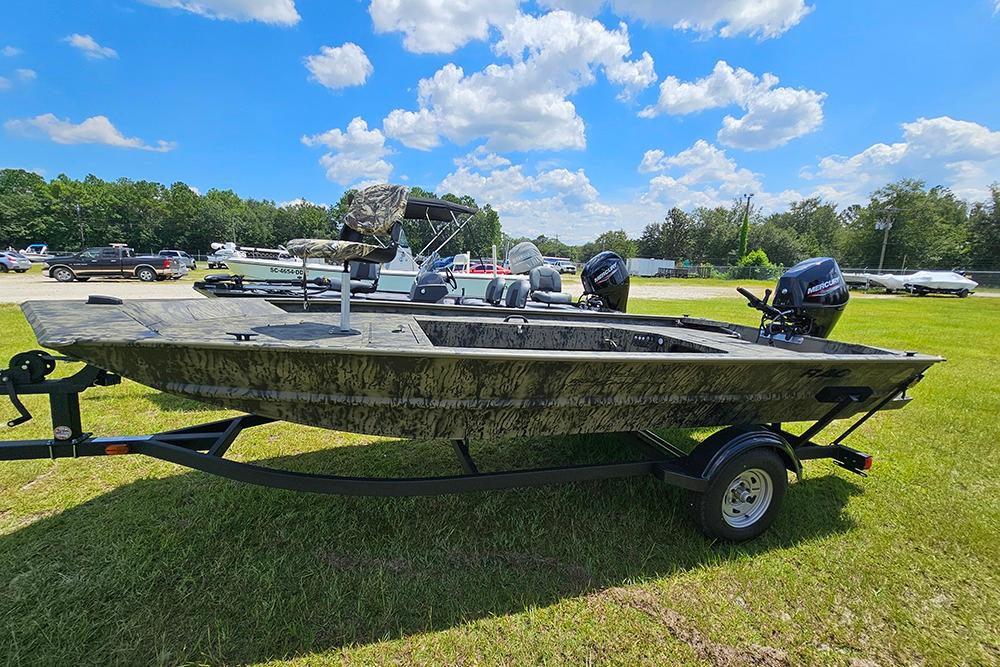 Tracker Grizzly 1654 T Sportsman 2026 Tracker Grizzly 1654 T Sportsman boat on trailer, parked on grass under blue sky.
