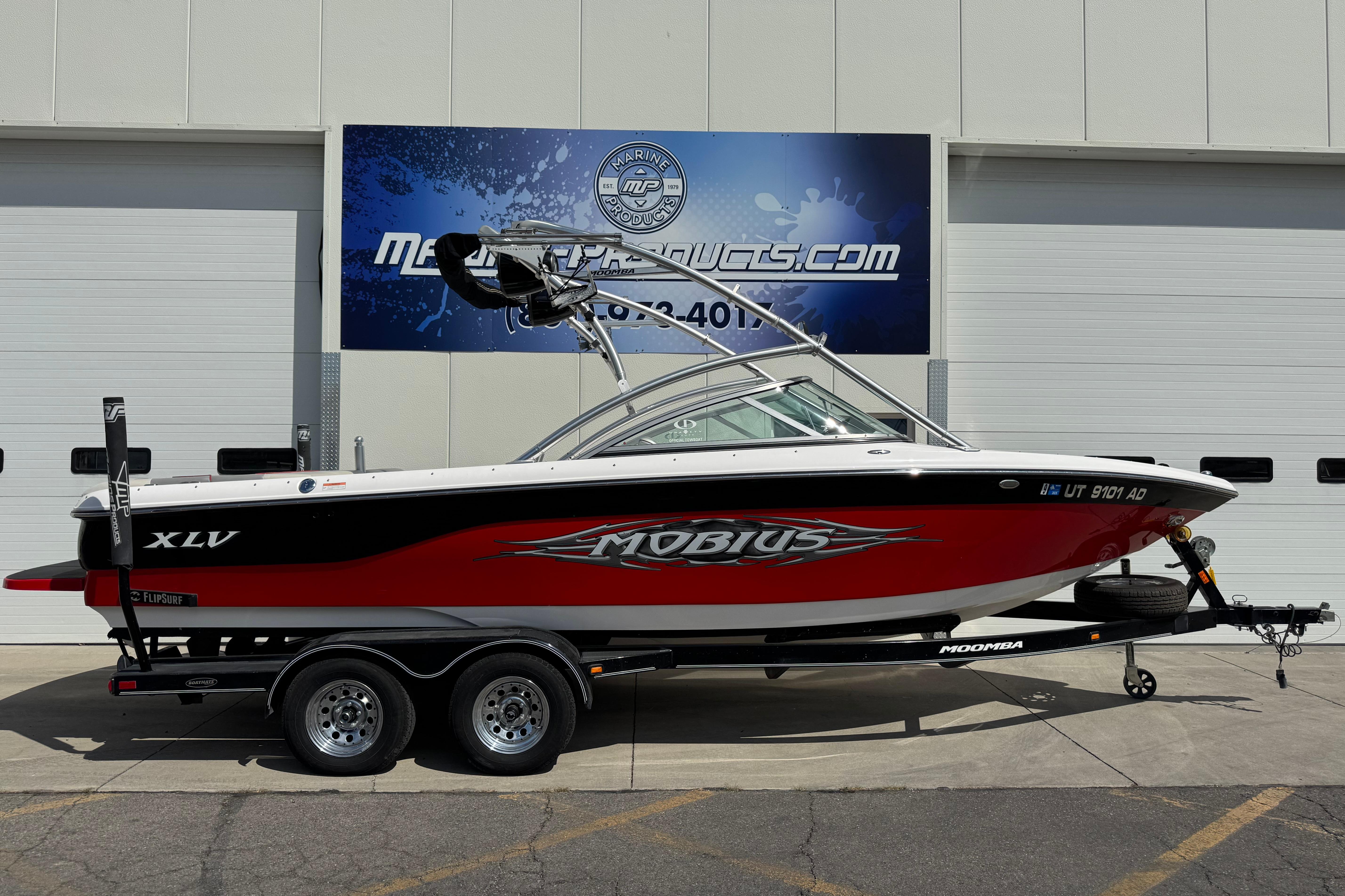 Moomba Mobius XLV 2006 Moomba Mobius XLV boat on trailer, parked outside a building.