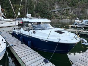 Jeanneau NC 795 S2 2021 Jeanneau NC 795 S2 boat docked in a serene marina setting.