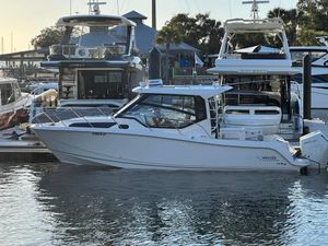 Boston Whaler 325 Conquest 2025 Boston Whaler 325 Conquest docked at marina, surrounded by other boats.