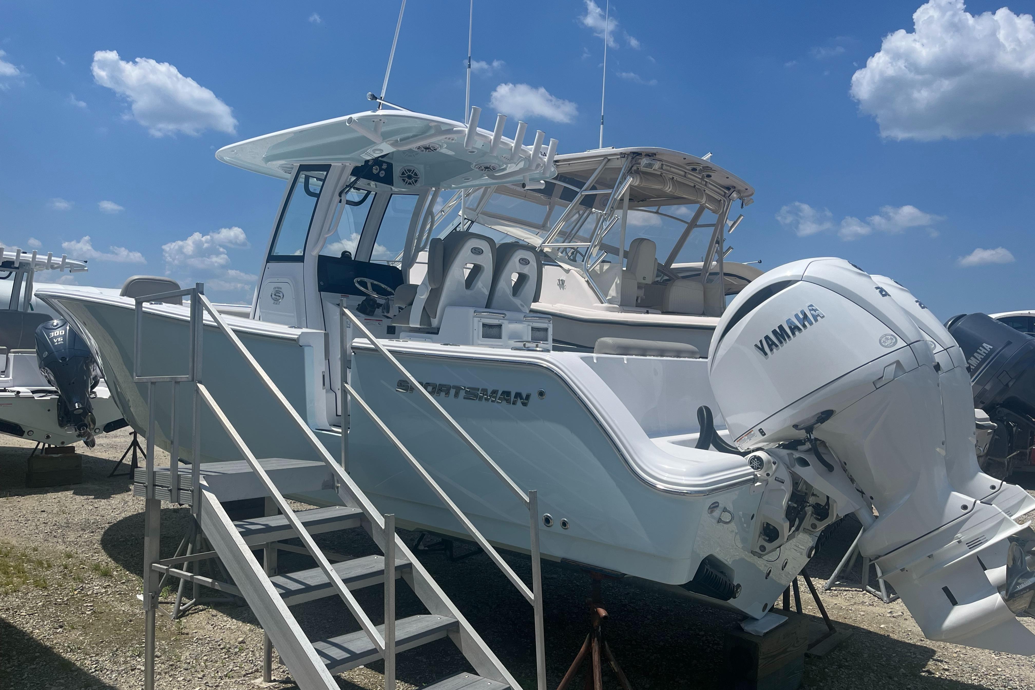 Sportsman Open 262 Center Console 2025 Sportsman Open 262 Center Console boat with Yamaha engine, displayed outdoors.