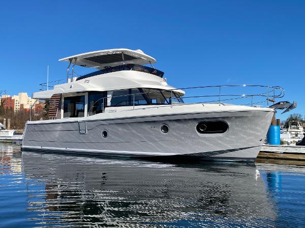 Beneteau Swift Trawler 48 2024 Beneteau Swift Trawler 48 docked in a marina on a sunny day.