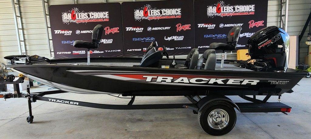Tracker Pro Team 190 2026 Tracker Pro Team 190 boat on trailer in showroom with branded backdrop.