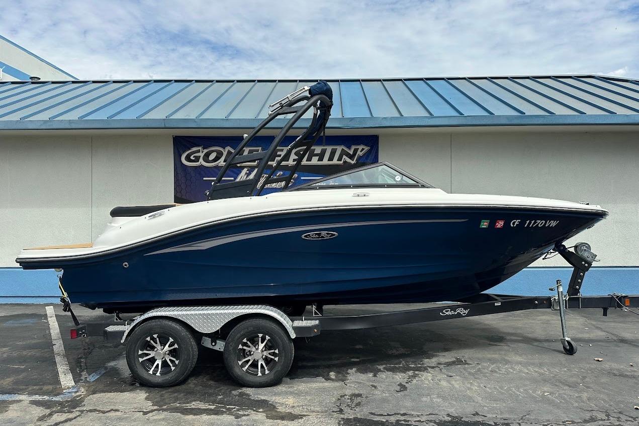 Sea Ray SPX 190 2022 Sea Ray SPX 190 boat on trailer, parked outside a building.