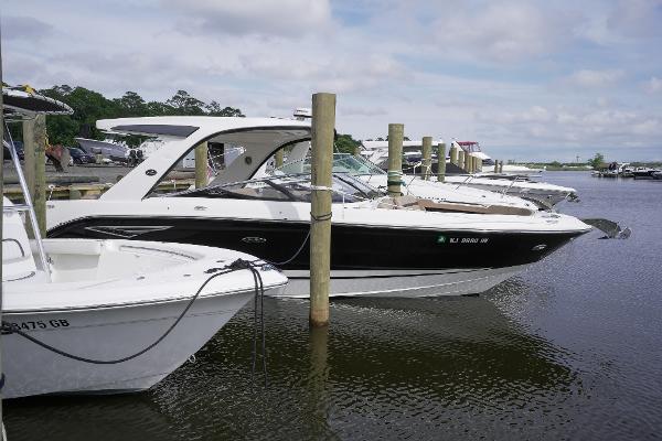 Sea Ray SLX 310 2017 Sea Ray SLX 310 boat docked at a marina on a cloudy day.