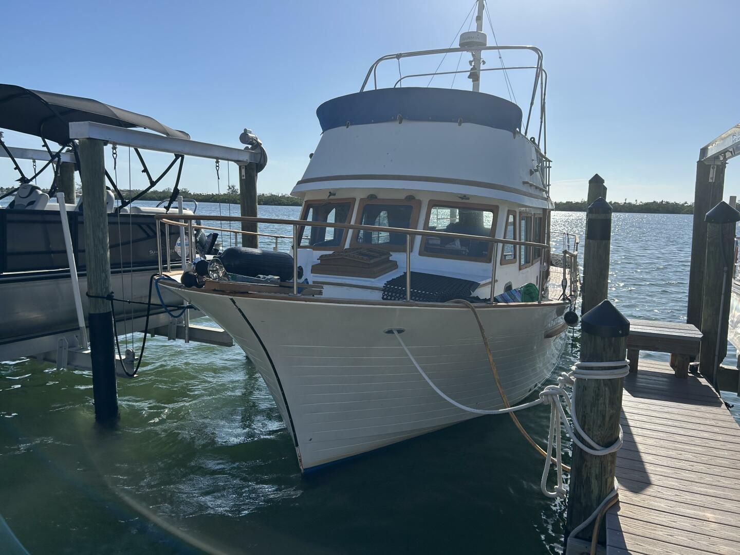 Albin 36 Trawler 1978 Albin 36 Trawler docked at a marina under clear blue skies.
