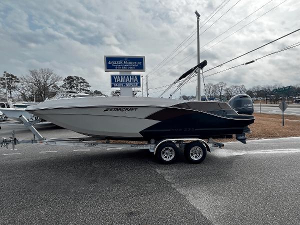 Starcraft SVX 231 2024 Starcraft SVX 231 boat on a trailer at a dealership.